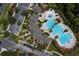 Aerial view of a community pool featuring a lazy river, lap pool, and splash pad for endless summer fun at 20606 Whitewood Way, Tampa, FL 33647
