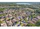 Wide aerial view showcasing a residential area with single-Gathering homes, some with pools, and a lake in the background at 2127 Landside Dr, Valrico, FL 33594