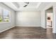 Spacious bedroom with hardwood floors, tray ceiling, and large window at 2127 Landside Dr, Valrico, FL 33594