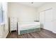 Bedroom with wood-look floors, a bed with drawers, a dresser and a closet at 2127 Landside Dr, Valrico, FL 33594