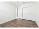 Bedroom with wood-look floors, neutral walls, and a closet with sliding doors at 2127 Landside Dr, Valrico, FL 33594