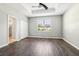 Well-lit bedroom featuring hardwood floors, a ceiling fan, and a walk-in closet at 2127 Landside Dr, Valrico, FL 33594