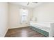 Comfortable bedroom with wood-look floors, a bed with drawers, and natural light at 2127 Landside Dr, Valrico, FL 33594
