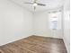 Bright bedroom features wood-look floors, modern ceiling fan, and natural light from the window at 2127 Landside Dr, Valrico, FL 33594