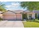 Charming single-story home with a three-car garage, well-manicured lawn, and inviting landscaping, perfect for Gathering living at 2127 Landside Dr, Valrico, FL 33594