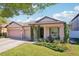 Attractive single-Gathering home with a three-car garage, lush front lawn, and inviting entrance, creating a warm and welcoming ambiance at 2127 Landside Dr, Valrico, FL 33594