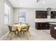Eat-in kitchen area with dark cabinets and view into main kitchen at 2127 Landside Dr, Valrico, FL 33594