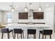 Open kitchen with a large island, pendant lighting, stainless steel appliances, and dark cabinetry at 2127 Landside Dr, Valrico, FL 33594