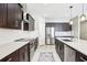 Stylish kitchen featuring stainless steel appliances, dark cabinets and elegant countertops at 2127 Landside Dr, Valrico, FL 33594