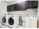 Laundry room featuring modern appliances, upper cabinets, and a sink at 2127 Landside Dr, Valrico, FL 33594