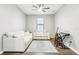 Bright living room features hardwood floors, a ceiling fan, and comfortable white seating at 2127 Landside Dr, Valrico, FL 33594