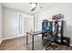 Home office with hardwood floors, dual doors, a modern desk, and ample shelving space at 2127 Landside Dr, Valrico, FL 33594