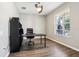 Office features wood floors, a ceiling fan, and a large window, offering a bright workspace at 2127 Landside Dr, Valrico, FL 33594