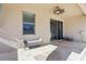 Covered patio with stone floors, seating, ceiling fan, and sliding glass doors to the interior at 2127 Landside Dr, Valrico, FL 33594