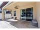 Covered patio with stone floors, seating, ceiling fan, and a partial view of the outdoors at 2127 Landside Dr, Valrico, FL 33594