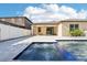 In-ground pool and jacuzzi provide a serene outdoor oasis, complete with a stone patio and covered seating area at 2127 Landside Dr, Valrico, FL 33594