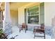 Cozy front porch with decorative stone pillars and seating area at 2127 Landside Dr, Valrico, FL 33594