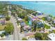 Aerial view of the neighborhood featuring homes, lush greenery, and a waterfront location with boats on the bay at 225 Cevera Dr, Dunedin, FL 34698