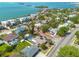 Residential neighborhood with lush landscaping and sparkling blue water in the distance at 225 Cevera Dr, Dunedin, FL 34698