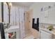 Bathroom featuring a sink with custom cabinet and shower with decorative curtain at 225 Cevera Dr, Dunedin, FL 34698