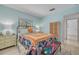 Cozy bedroom featuring a large bed, light wood floors, and ample natural light at 225 Cevera Dr, Dunedin, FL 34698