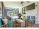 Spacious covered patio with grill, ceiling fan and view of the pool at 225 Cevera Dr, Dunedin, FL 34698