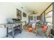 Covered patio with grill, ceiling fan and outdoor seating area at 225 Cevera Dr, Dunedin, FL 34698