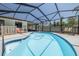 Inviting pool area surrounded by a screened enclosure and a lounge area, perfect for outdoor relaxation and entertaining at 225 Cevera Dr, Dunedin, FL 34698