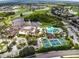 Aerial view of a golf course community featuring a clubhouse, pools and tennis courts at 2333 Brookfield Greens Cir, Sun City Center, FL 33573