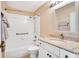 Well-lit bathroom featuring a shower/tub, white vanity with granite countertop, and modern fixtures at 2333 Brookfield Greens Cir, Sun City Center, FL 33573