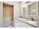 Bright bathroom featuring double sinks, granite countertops, modern fixtures, and tile flooring at 2333 Brookfield Greens Cir, Sun City Center, FL 33573