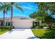 Charming single-story home with a two-car garage, neat landscaping, and palm trees in a sunny setting at 2333 Brookfield Greens Cir, Sun City Center, FL 33573