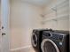 Laundry room showcases newer, front-loading washer and dryer set and wire shelving at 2333 Brookfield Greens Cir, Sun City Center, FL 33573