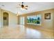 Spacious living room with tile flooring, neutral walls, natural light, and views of the outdoors at 2333 Brookfield Greens Cir, Sun City Center, FL 33573