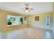 Open living room featuring neutral walls, tile flooring, a ceiling fan, and lots of natural light at 2333 Brookfield Greens Cir, Sun City Center, FL 33573