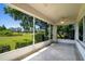Relaxing screened patio with ceiling fan and expansive views of the landscaped backyard and blue sky at 2333 Brookfield Greens Cir, Sun City Center, FL 33573