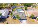 Aerial view of home with a screened-in pool, fenced yard, mature landscaping, and a private backyard at 2435 Comerwood Dr, Spring Hill, FL 34609