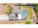 Overhead aerial view of the property showcasing a screened-in pool, solar panels and fenced yard at 2435 Comerwood Dr, Spring Hill, FL 34609