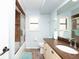 Charming bathroom with granite counters, wood-look tile, shower/tub combo, and window at 2435 Comerwood Dr, Spring Hill, FL 34609