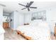 Bedroom featuring a large bed, modern ceiling fan and light wood-look flooring at 2435 Comerwood Dr, Spring Hill, FL 34609