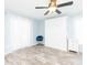 Bright bedroom with murphy bed, modern ceiling fan and light wood-look flooring at 2435 Comerwood Dr, Spring Hill, FL 34609