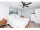 Bedroom featuring a large bed, modern ceiling fan and light wood-look flooring at 2435 Comerwood Dr, Spring Hill, FL 34609