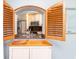 A well-lit kitchen featuring wood shutters that open to a breakfast bar at 2435 Comerwood Dr, Spring Hill, FL 34609