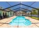 Outdoor screened-in swimming pool with a paver patio and access to the backyard at 2435 Comerwood Dr, Spring Hill, FL 34609