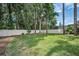 Beautiful, well-maintained backyard with green grass and a white fence for privacy and seclusion from neighbors at 2486 Indian E Trl, Palm Harbor, FL 34683