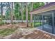 Large backyard with mature trees and a lawn, also showing the deck, and a fence offering privacy at 2486 Indian E Trl, Palm Harbor, FL 34683