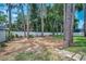 Lawn and fence in a private backyard featuring mature trees that offer shade and a sense of seclusion at 2486 Indian E Trl, Palm Harbor, FL 34683