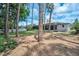 Backyard featuring mature trees and landscaping surrounding the property and a fence offering privacy at 2486 Indian E Trl, Palm Harbor, FL 34683