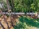Aerial view of fenced backyard surrounded by beautiful trees, showcasing space and privacy at 2486 Indian E Trl, Palm Harbor, FL 34683