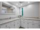 Bathroom vanity with marble countertops, white cabinets, and modern finishes at 2486 Indian E Trl, Palm Harbor, FL 34683